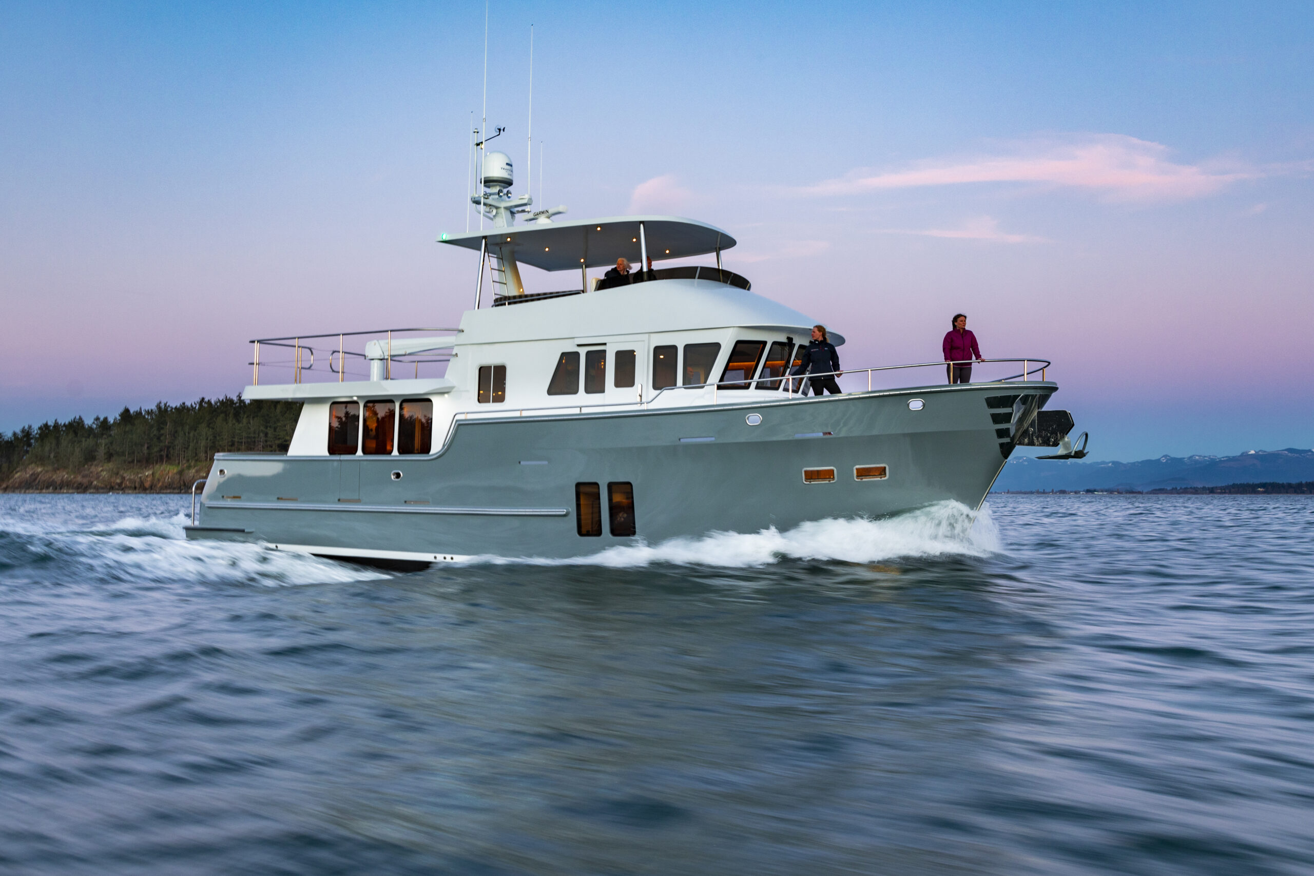 Northern Marine yacht running at golden hour with dramatic sunset lighting